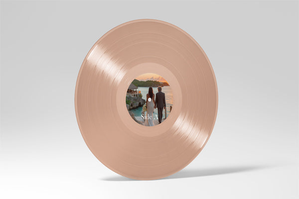 Custom rose gold 12-inch vinyl record with personalized photo label of couple holding hands at sunset. Unique custom vinyl pressing for weddings, anniversaries, romantic gifts, and personalized music keepsake