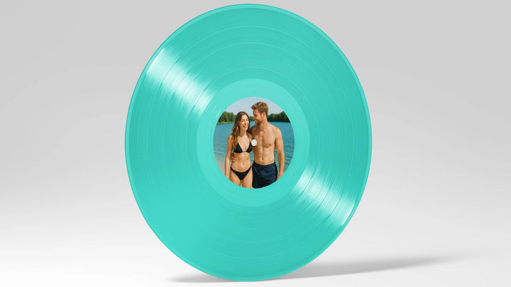 Turquoise vinyl record with a picture of a couple on a gray background