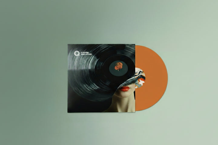 Orange vinyl record with a women's face on the cover against a light green background