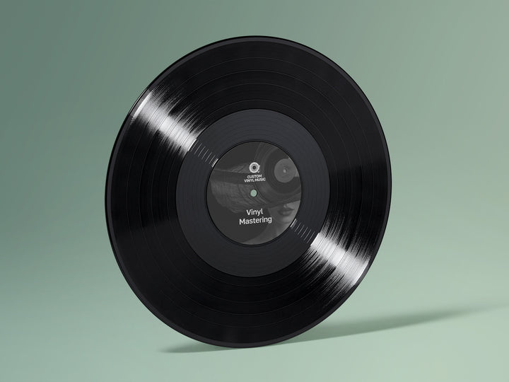 Black vinyl record with a label on a green background